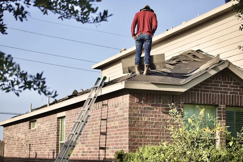 Professional roofer working on a residential roof in Stockman Estates